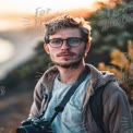 Young Male Photographer with Camera at Sunset - Outdoor Portrait