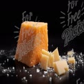 Artisan Cheddar Cheese Block with Shavings on Dark Background