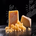 Artisan Cheese Selection with Crumbled Texture on Dark Background