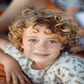 Joyful Child Portrait with Curly Hair and Freckles - Natural Smiles and Playful Expressions