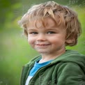 Joyful Child Portrait in Nature - Happy Boy with Curly Hair and Bright Eyes