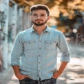 Confident Young Man in Urban Setting with Autumn Background