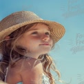 Joyful Summer Moments: Young Girl in Sun Hat Against Clear Blue Sky