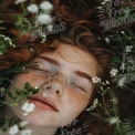 Serene Beauty: Young Woman with Freckles and Red Hair Surrounded by Wildflowers