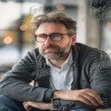 Thoughtful Businessman in Modern Workspace: Professional Portrait with Bokeh Background