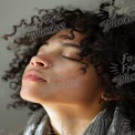 Serene Portrait of a Young Woman with Curly Hair in Natural Light