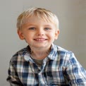 Cheerful Young Boy with Bright Blue Eyes and Friendly Smile