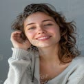 Natural Beauty Portrait of a Smiling Young Woman with Curly Hair