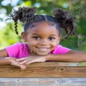 Joyful Young Girl with Playful Hair in Nature - Childhood Happiness and Outdoor Fun