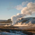 Majestic Geyser Erupting in Winter Landscape at Sunrise