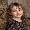 Joyful Child Portrait with Curly Hair on Floral Background