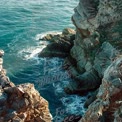 Serene Coastal Cliffs with Turquoise Waves: Nature's Majestic Seascape