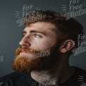 Stylish Portrait of a Bearded Man with Freckles and Thoughtful Expression