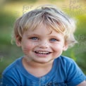 Joyful Child with Bright Blue Eyes Smiling Outdoors