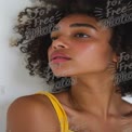 Natural Beauty Portrait of a Young Woman with Curly Hair and Radiant Skin