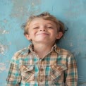 Cheerful Young Boy Smiling Against Colorful Background - Joyful Childhood Portrait