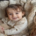 Adorable Smiling Toddler in Cozy Knit Blanket - Childhood Joy and Innocence