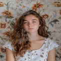 Natural Beauty Portrait with Floral Background - Youthful Woman with Curly Hair