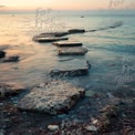 Tranquil Seascape with Stone Pathway at Sunset