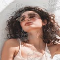 Trendy Summer Fashion: Stylish Woman with Curly Hair and Sunglasses