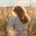 Serene Woman in Sweater Amidst Golden Field at Sunset