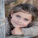 Charming Young Girl with Braids and Bright Blue Eyes in Cozy Sweater