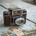 Vintage Camera on Weathered Wood: Nostalgic Photography Equipment