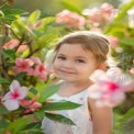 Joyful Child Among Blooming Flowers: Captivating Spring Portrait