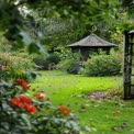 Tranquil Garden Retreat with Gazebo Surrounded by Vibrant Flowers