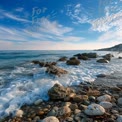 Tranquil Coastal Landscape with Waves and Rocky Shoreline Under Blue Sky