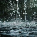 Close-Up of Raindrops Splashing on Water Surface - Nature's Refreshing Beauty