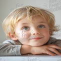 Charming Young Boy with Playful Expression and Bright Blue Eyes