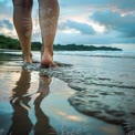 Serene Beach Walk: Tranquil Reflections on Sandy Shore at Sunset