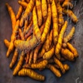 Vibrant Fresh Turmeric Roots on Rustic Background - Organic Spices and Health Benefits