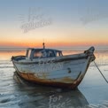 Abandoned Fishing Boat at Sunrise on Tranquil Beach