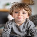 Charming Young Boy with Playful Smile in Cozy Home Setting