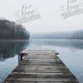 Tranquil Foggy Lake with Wooden Pier at Dawn