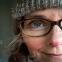 Close-Up Portrait of a Woman in Winter Hat with Warm Expression