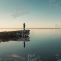 Serene Solitude: Person Standing on Rocky Shore at Sunrise Over Calm Water