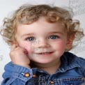 Adorable Child Portrait with Curly Hair and Bright Blue Eyes