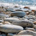 Tranquil Beach Stones: Natural Coastal Landscape with Smooth Pebbles and Gentle Waves